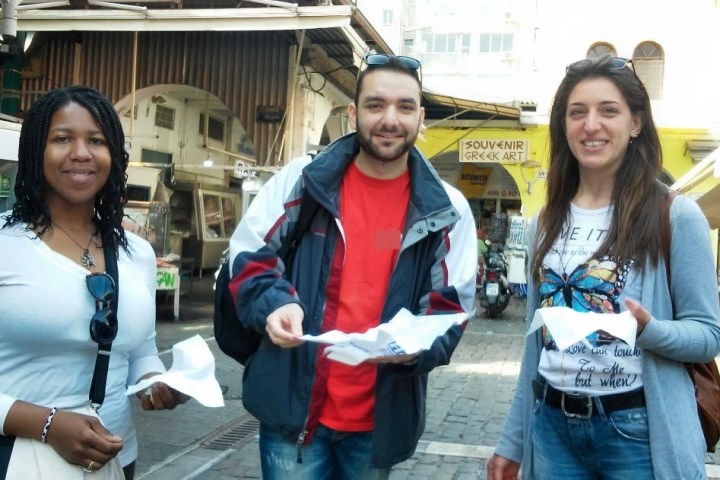 a woman standing next to a building