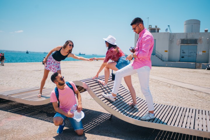 a group of people sitting at a beach