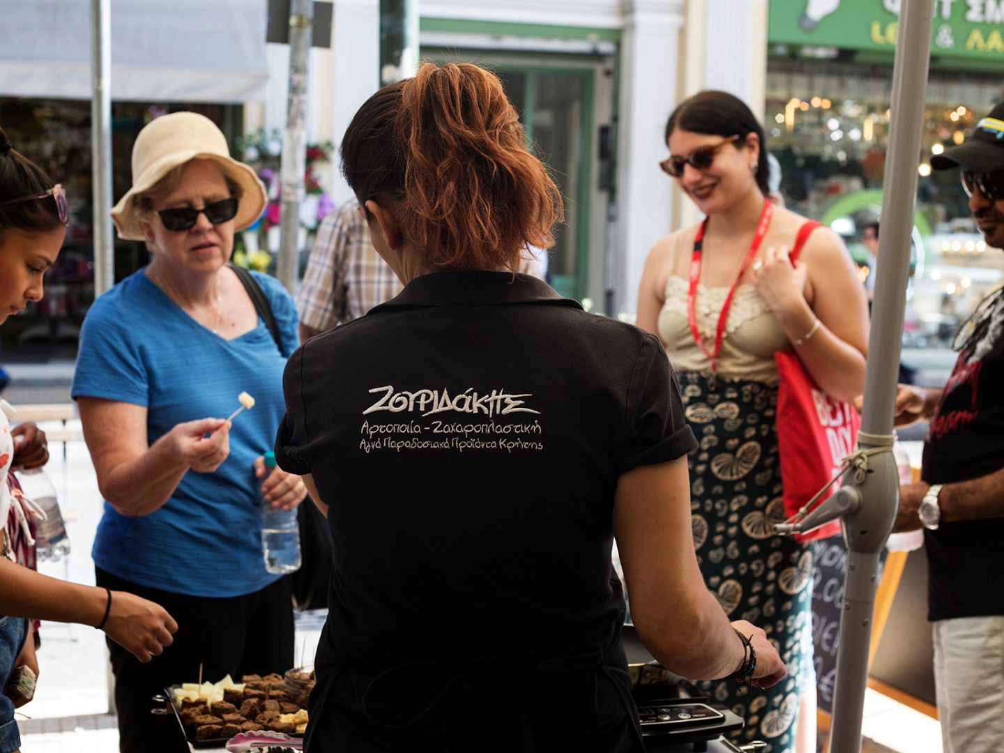 a group of people standing around a cake