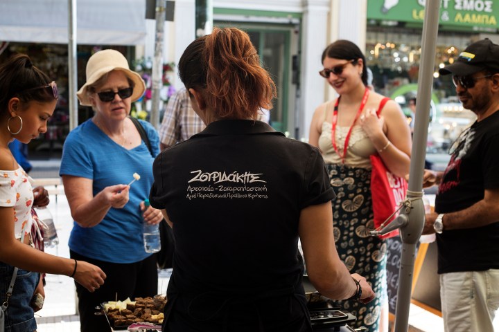 a group of people standing around a cake